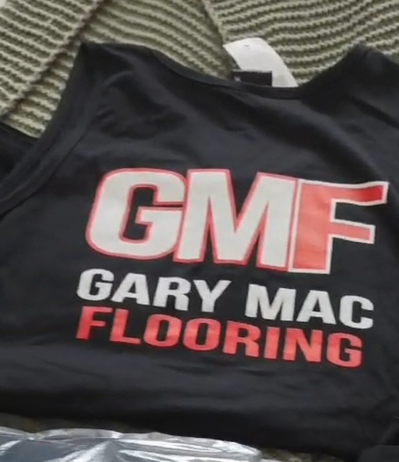 Black GMF Gary Mac Flooring singlet with red and white logo